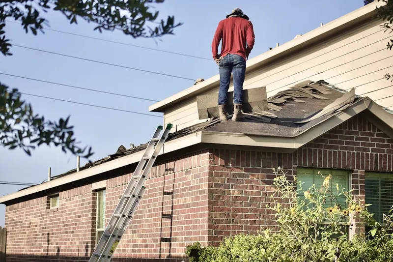 Professional roofer working on a residential roof in Croasdaile Farm Master